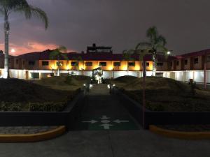 un bâtiment de nuit avec un chemin menant à celui-ci dans l'établissement Hotel & Villas 7, à Mexico