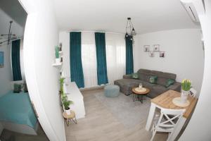 a living room with a couch and a table at Apartman Lucija in Karlovac