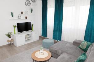 a living room with a couch and a tv at Apartman Lucija in Karlovac