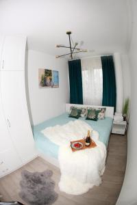 a bedroom with a bed with a table in it at Apartman Lucija in Karlovac