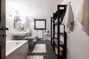 a bathroom with a sink and a toilet and a tub at Rotonda 23 - Loft in Pantheon in Rome +34 photos