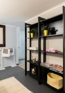 a black book shelf with potted plants in a room at Rotonda 23 - Loft in Pantheon in Rome