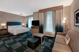 a hotel room with a bed and a couch at Homewood Suites By Hilton Austin/Cedar Park-Lakeline, Tx in Austin