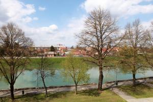 a group of trees next to a body of water at Apartman Lucija in Karlovac