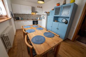 a kitchen with a wooden table with blue plates on it at B&B I FAGGI in Lavarone