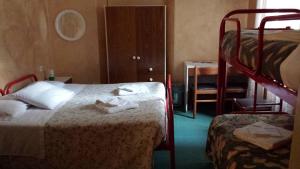 a bedroom with two beds and a bunk bed at Nouveau Mirabeau in Bellagio