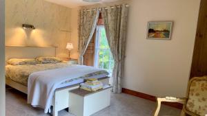 a bedroom with a bed and a window at Lacken Millhouse and Gardens in Cavan