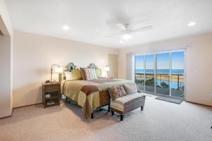 a bedroom with a bed and a view of the ocean at Top of the World in Tillamook
