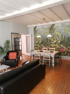 a living room with a couch and a table at La Maison de Jeanne in Dieppe
