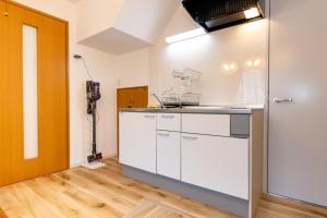 a kitchen with white cabinets in a room at BOUTOU - Vacation STAY 34136v in Tokyo