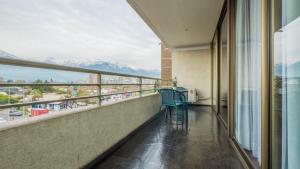 a balcony with chairs and a view of mountains at My Aparts SCL in Santiago