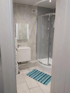a bathroom with a shower and a sink at Amble Holiday Home in Amble +56 photos
