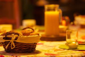 un cesto di pane su un tavolo con un bicchiere di succo d'arancia di Chambres d'Hôtes Garicoitz a Saint-Jean-Pied-de-Port Altre 24 foto