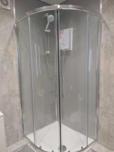 a shower in a bathroom with a glass enclosure at Amble Holiday Home in Amble