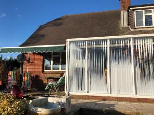 a house with a white screened in porch at Ponders End in Shide
