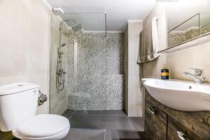a bathroom with a toilet and a sink and a shower at CENTRO PATRAS in Patra +47 photos