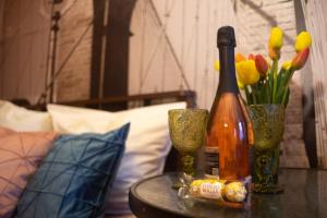 a bottle of wine sitting on a table with flowers at Guest House on 174А Shevchenko Street in Anapa