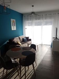 a living room with a table and a couch at Appartement le Michel ange in Briançon
