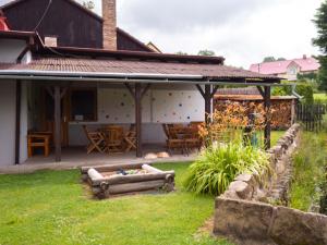 a backyard of a house with a fire pit at Penzion U Cempu in Kunratice