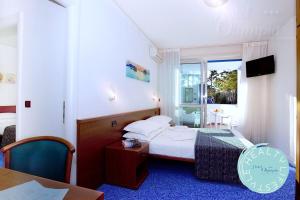 Postel nebo postele na pokoji v ubytování Hotel Olympia