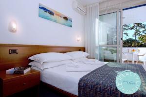 Postel nebo postele na pokoji v ubytování Hotel Olympia