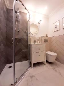 a bathroom with a shower and a toilet at Willa Balticana in Władysławowo +102 photos
