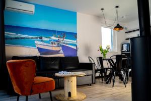 a living room with a couch and a table at Dream-House in Kopalino