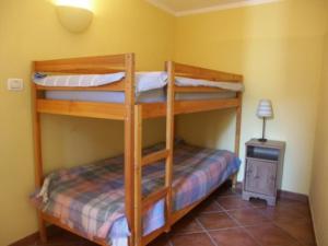 a bedroom with two bunk beds in a room at Casetta n.2 con piscina in Sarola