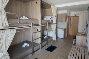 a room with two bunk beds and a kitchen at Nereida in Horta