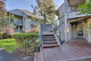 a house with a wooden staircase in front of a house at River Ridge 416B condo in Bend