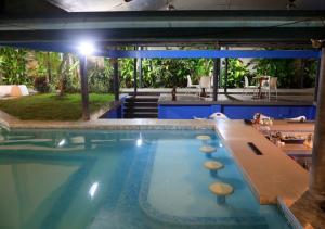 a pool at a resort with a table and chairs at Samiria Jungle Hotel in Iquitos