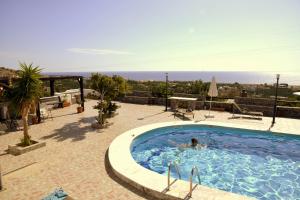 a person is swimming in a swimming pool at Filoxenia Villa in Koutsounari