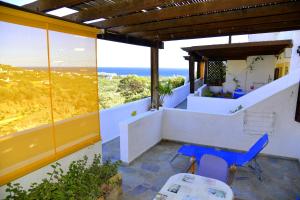 a house with a view of the ocean from a balcony at Filoxenia Villa in Koutsounari