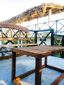a wooden bench sitting on top of a table at La Casa de las Aves in Bacalar