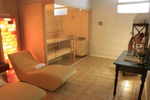 a bathroom with a shower and a chair and a table at Albergo & Ristorante Selvatico in Rivanazzano