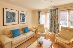 a living room with a couch and two chairs at Host & Stay - The Scuttlebutt Townhouse in Whitby
