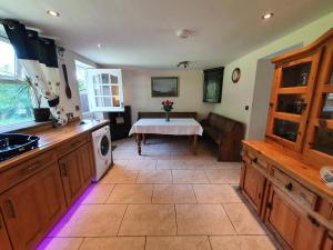 a kitchen with a sink and a table at Low Chesters House in Burtree Ford