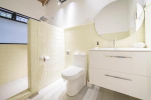 a bathroom with a toilet and a sink and a mirror at Soy Local Primavera in Medellín +119 photos