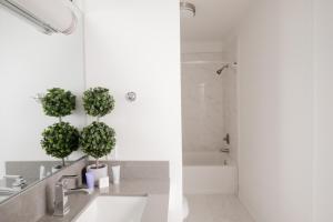 a bathroom with a sink and two potted plants at Hollywood Hills Hotel in Los Angeles