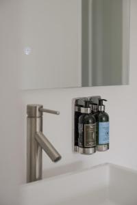 a bathroom sink with two bottles on a shelf at Hollywood Hills Hotel in Los Angeles