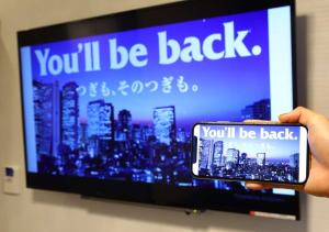 A television and/or entertainment centre at APA Hotel Shimbashi Toranomon