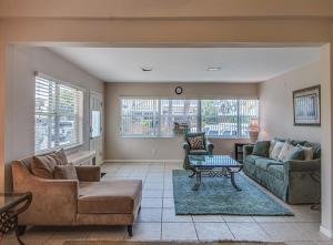 a living room with a couch and a table at Beachcomber Beach House - Weekly Rental Just Steps to White Sand Beach! home in Clearwater Beach