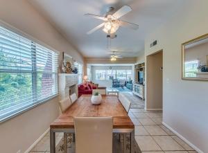 a dining room with a table and a ceiling fan at Beachcomber Beach House - Weekly Rental Just Steps to White Sand Beach! home in Clearwater Beach