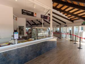 a food court with a counter in a store at Villa in Albarella near Venice Beach in Isola Albarella
