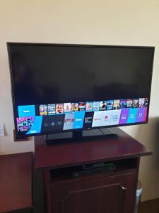 a flat screen tv sitting on top of a wooden table at Australian Heritage Motor Inn in Dubbo