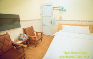 Postel nebo postele na pokoji v ubytování Tigon Flower House