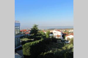 a city with a tall building and a tree at Τraditional fully detached villa on a luxurious hillock of Thessaloniki with its own garden also for family & wedding gatherings for 10 to 25 people only 15 minutes from airport in Thessaloniki