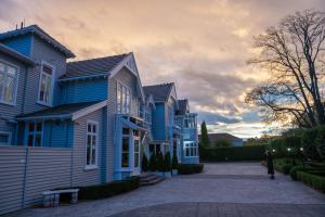 a row of blue houses in a driveway at Eliza's Manor in Christchurch