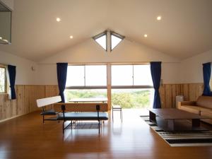 a living room with a couch and a table at Matsue Forest Park in Matsue