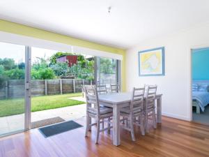 a dining room with a table and chairs at Summer In Blairgowrie in Blairgowrie